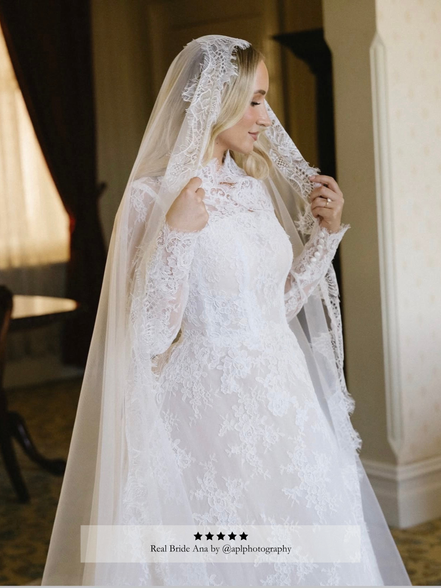 Bride wearing a ivory lace wedding dress and a Chantilly lace mantilla veil by Harriett Falvey