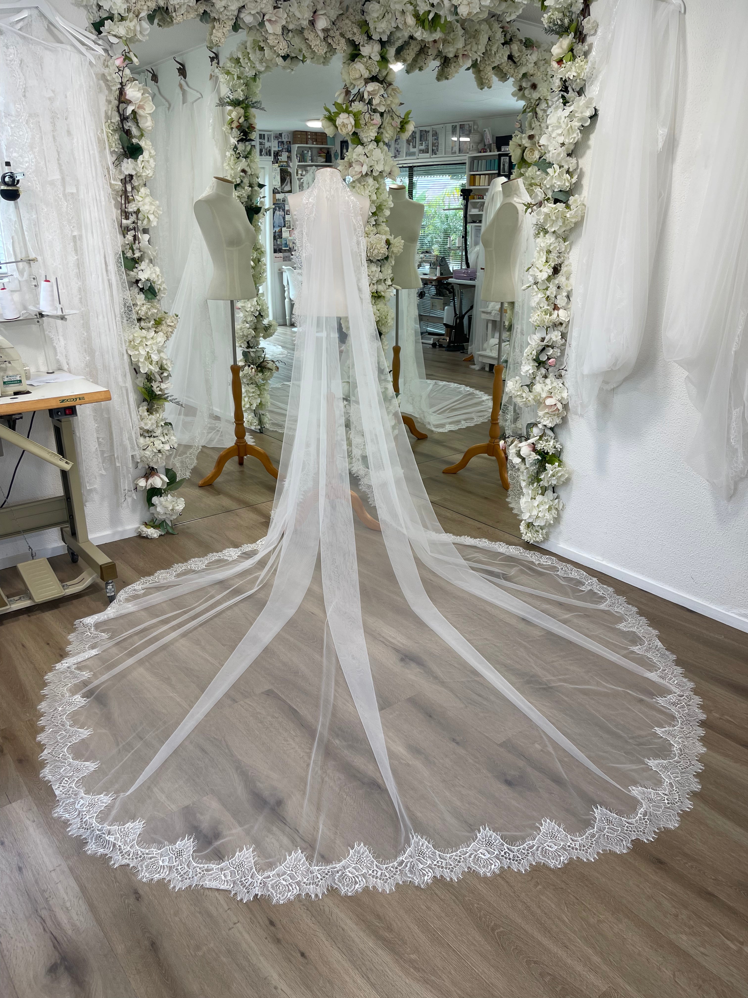 Extra wide tulle and chantilly lace mantilla veil as seen on a mannequin in Harriett Falvey bridal studio.