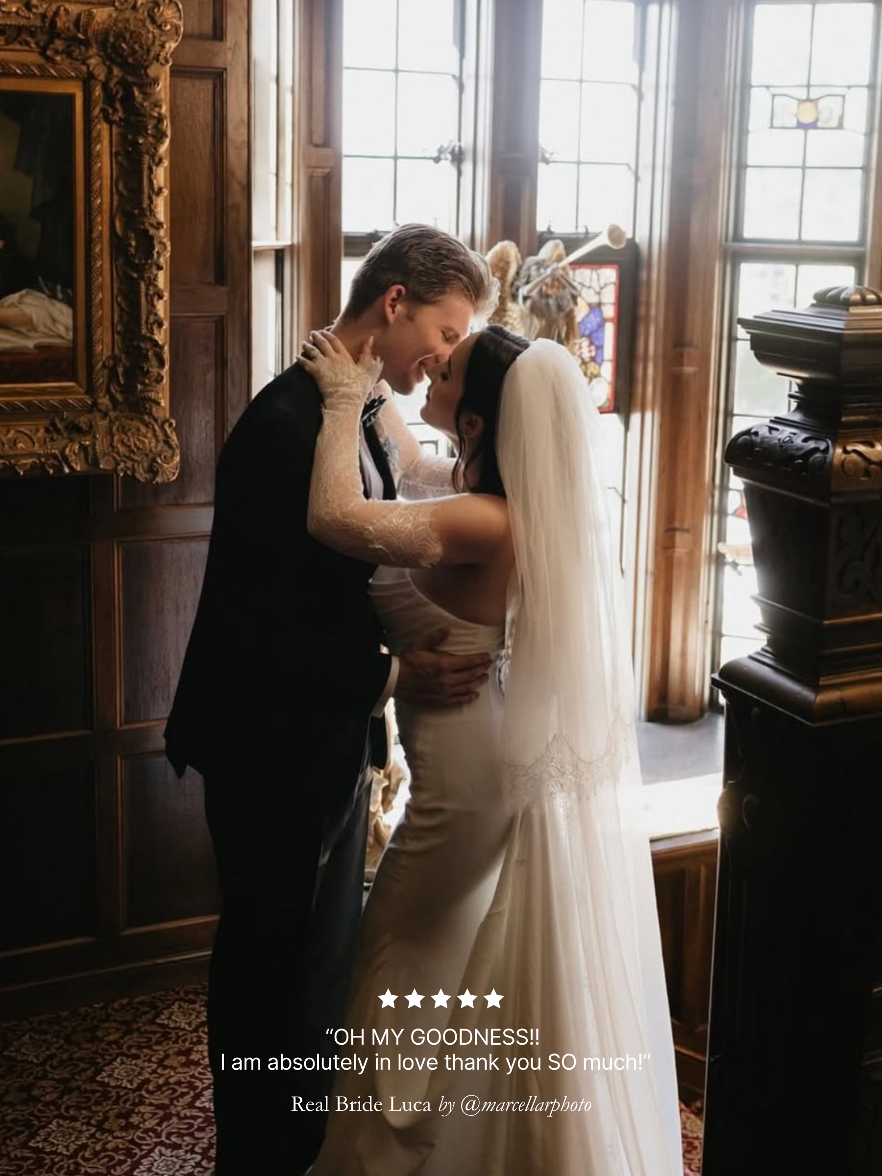 Wedding couple embracing in a grand room with ornate decor. Bride wearing a Harriett Falvey blusher veil and double edged lace gloves. 
