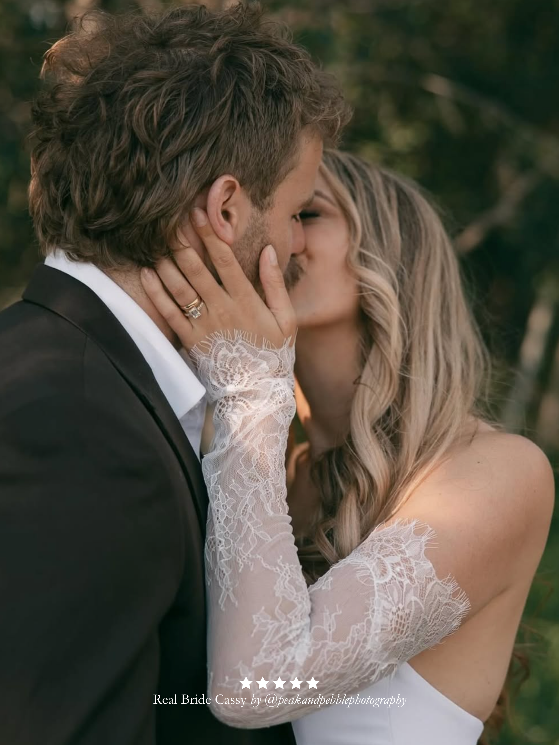 Couple sharing a kiss with a blurred natural background. Bride wearing Harriett Falvey double edged lace gloves and a five star review overlay.