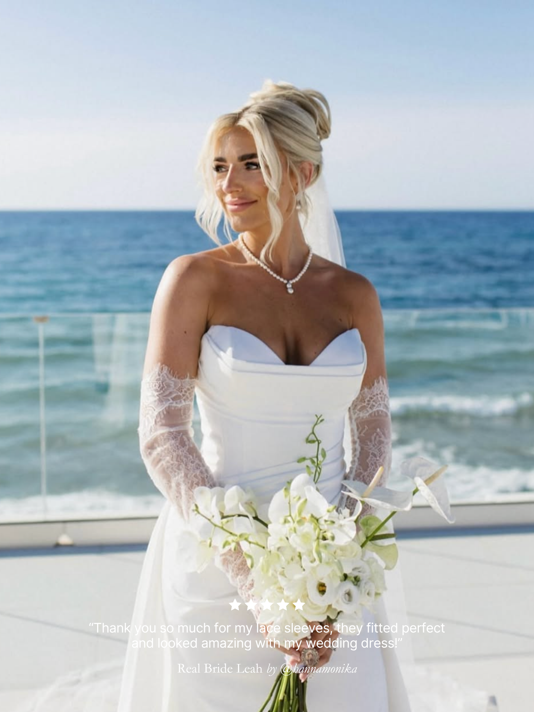 Real bride wearing Harriett Falvey double edged lace gloves, holding a bouquet with the ocean in the background. With five star review overlay