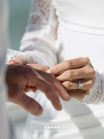 Close-up of a real bride wearing Harriett Falvey double edged lace gloves and a wedding ring, with a blurred background. With five star review overlay