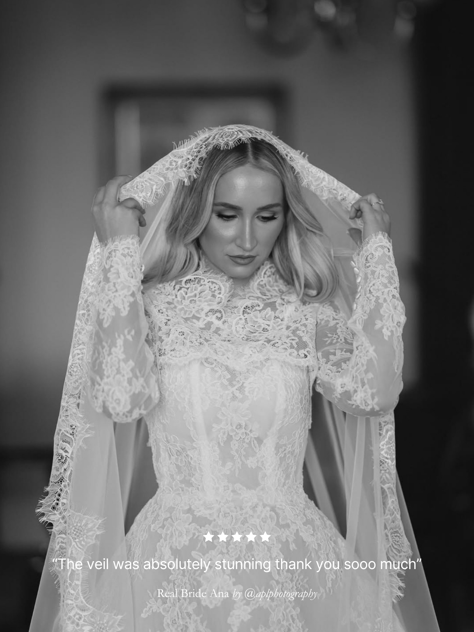Black and white photo of a bride wearing a lace wedding dress and extra wide chantilly lace mantilla veil. Five star review.