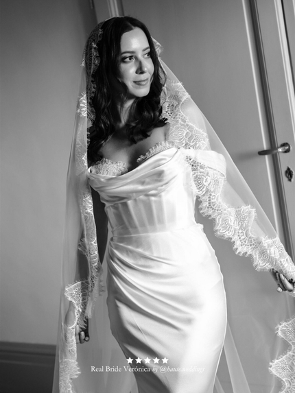 Black and white photo of real bride wearing a wedding dress with her extra wide chantilly lace veil by Harriett Falvey.