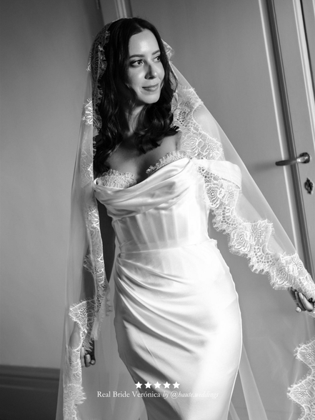 Black and white photo of real bride wearing a wedding dress with her extra wide chantilly lace veil by Harriett Falvey.