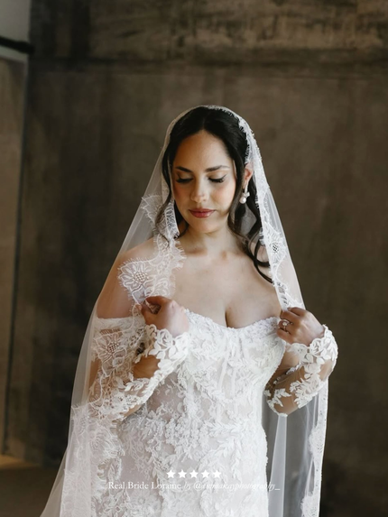 Real bride wearing her wedding attire with her Harriett Falvey extra wide chantilly like mantilla veil. With a five star overlay.