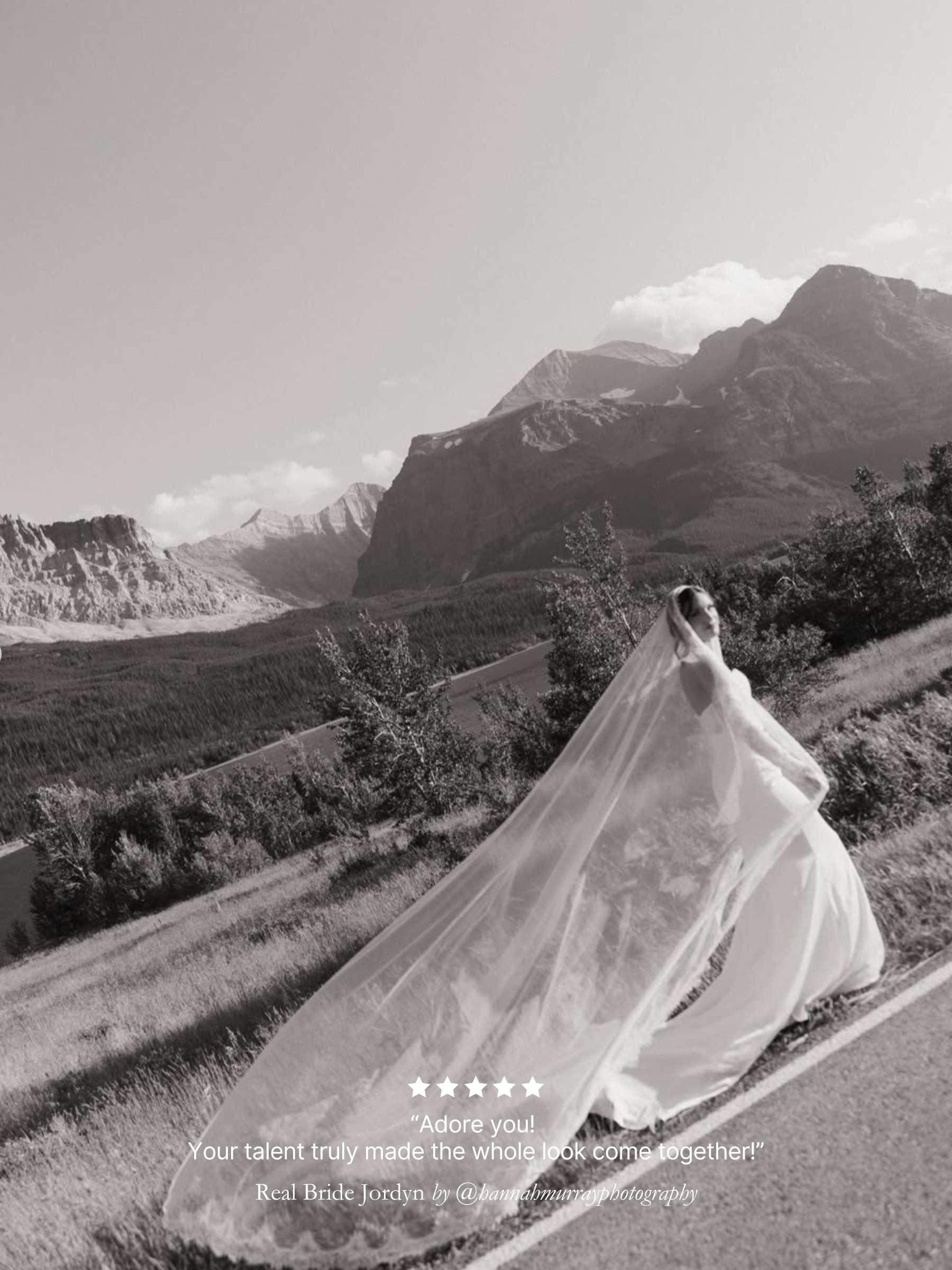 Black and white photo of Real bride walking along wearing her Harriett Falvey extra wide chantilly lace mantilla veil, with mountains behind her.