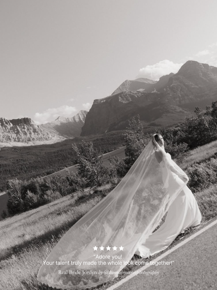 Black and white photo of Real bride walking along wearing her Harriett Falvey extra wide chantilly lace mantilla veil, with mountains behind her.