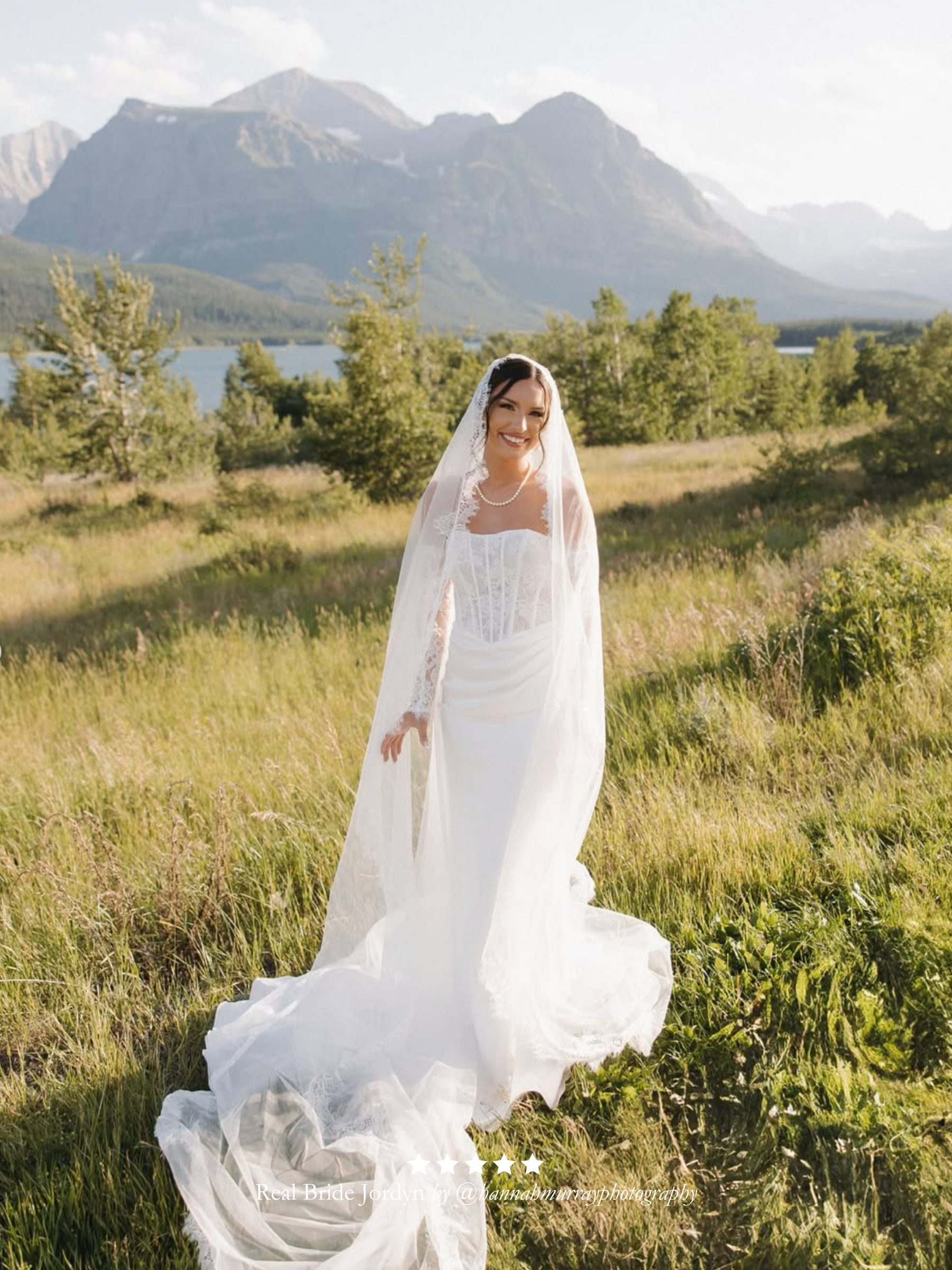 Woman in a white wedding dress standing in a field with mountains in the background wearing her Harriett Falvey extra wide chantilly lace mantilla veil. With five star review overlay.