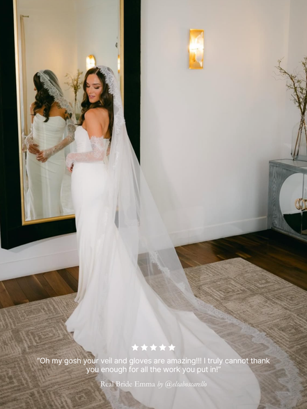 Real bride wearing her Chantilly lace mantilla veil in front of a mirror with a five-star rating text review overlay.