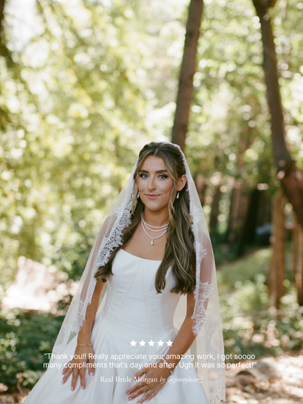 Bride in a wedding dress with her Harriett Falvey classic Chantilly lace mantilla veil standing in a forest