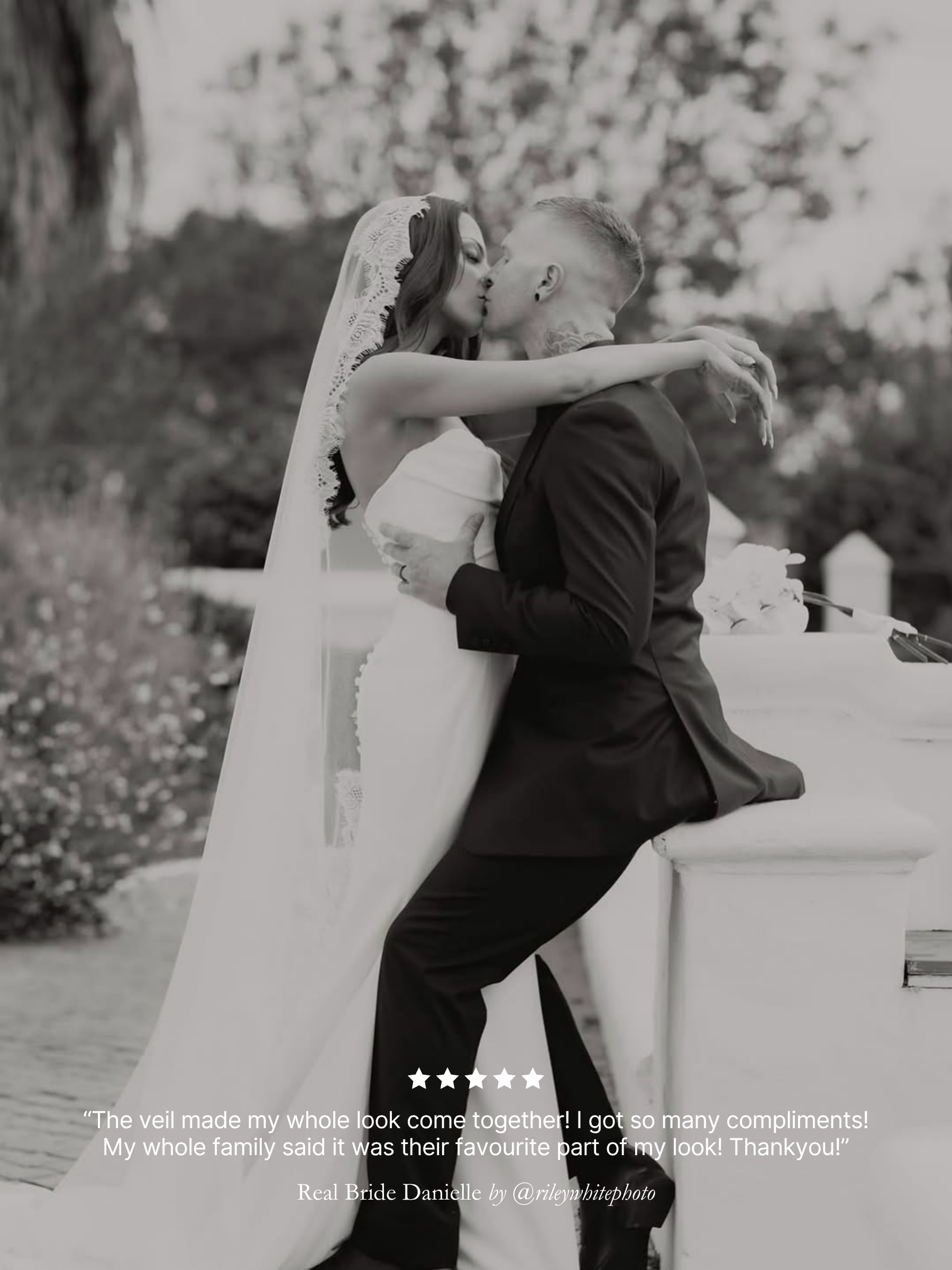 Black and white image of a bride and groom embracing with 5 star review text overlay. featuring her chantilly lace mantilla veil by Harriett Falvey