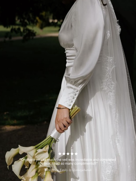 Bride in a white wedding dress holding a bouquet with a blurred background, featuring her chantilly lace mantilla veil by Harriett Falvey with review overlay