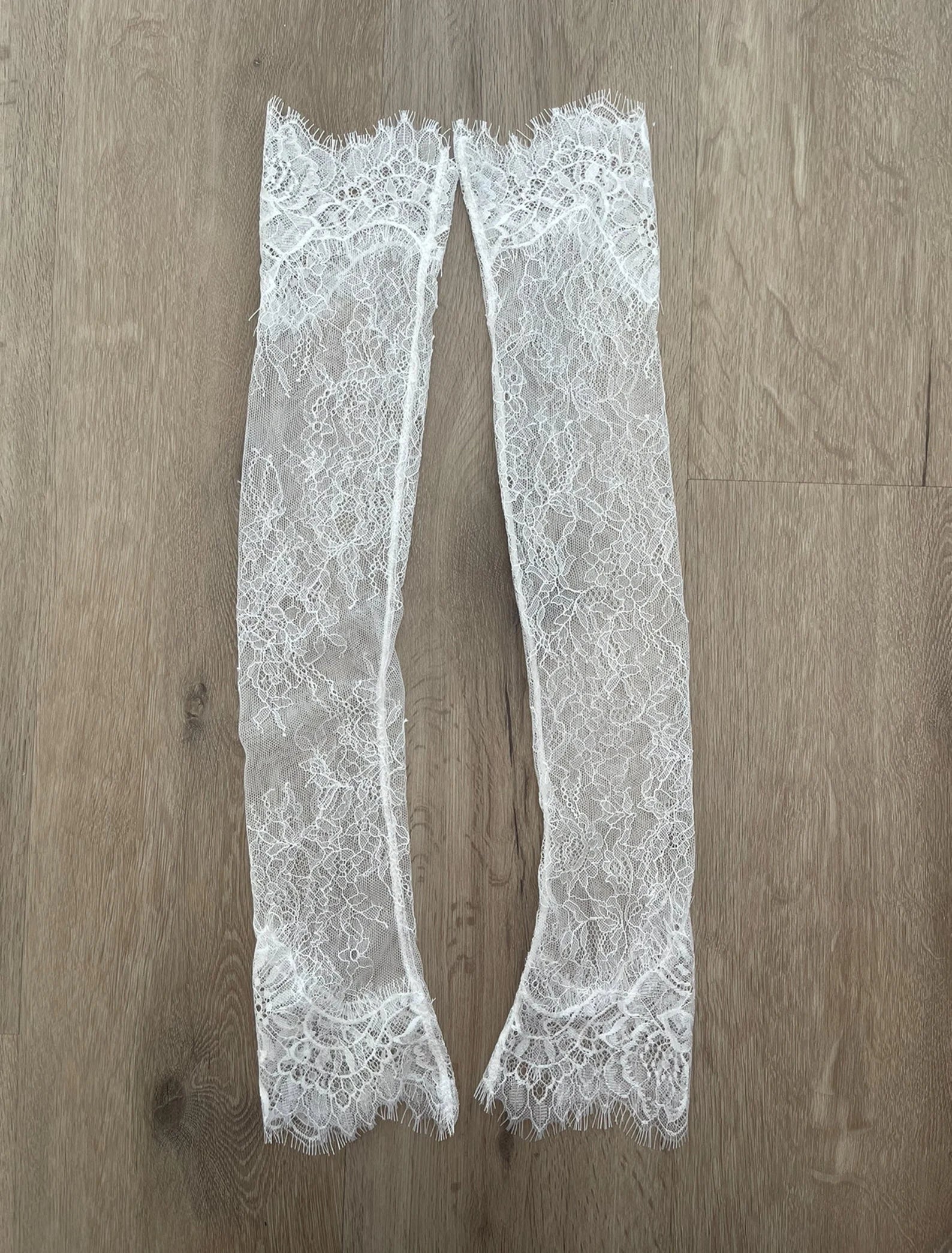 Harriett Falvey double edged lace gloves flatlay on wooden background. bridal gloves, wedding gloves 