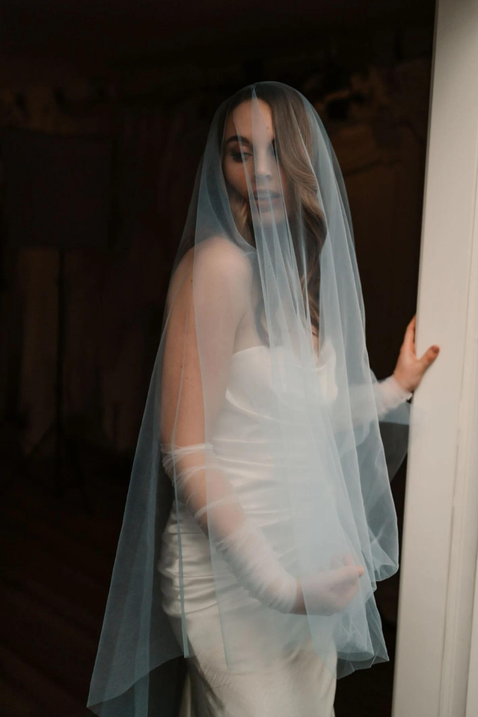 Model Styling the Blue Blusher Veil designed by Harriett Falvey, New Zealand Bridal Designer