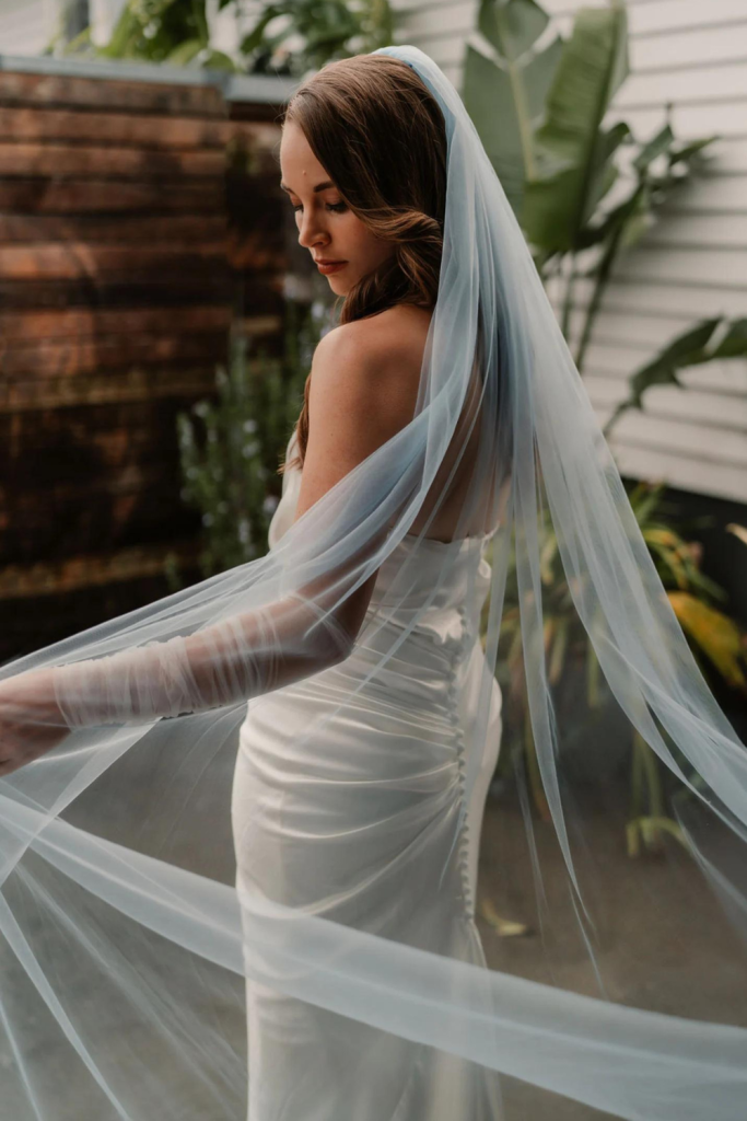 Model styling the Blue Veil designed by Harriett Falvey, New Zealand Bridal Designer