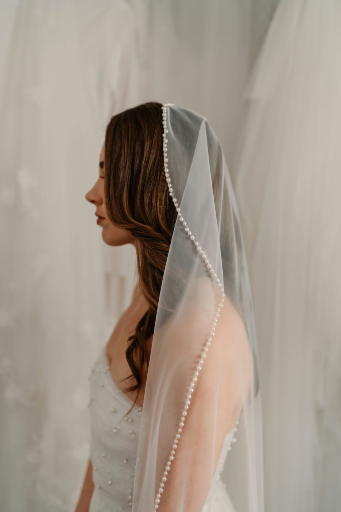 Studio shot of the Pearl Trim Mantilla Veil by Harriett Falvey, New Zealand Bridal Designer