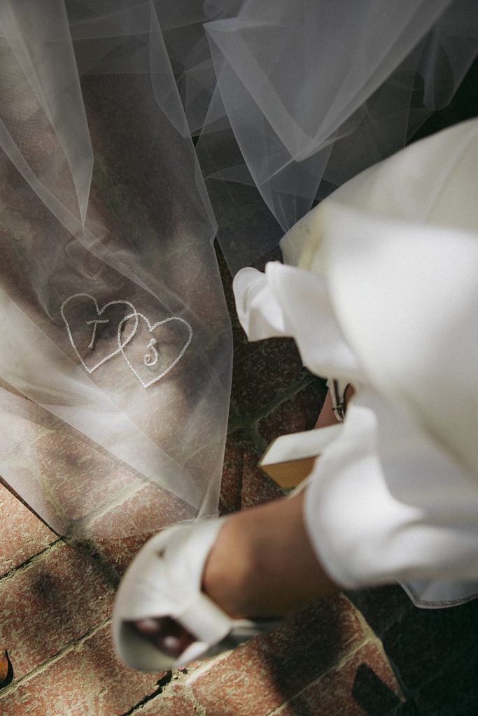 Real Bride Sara wearing her custom tulle blusher veil by Harriett Falvey | Custom Bridal Designer