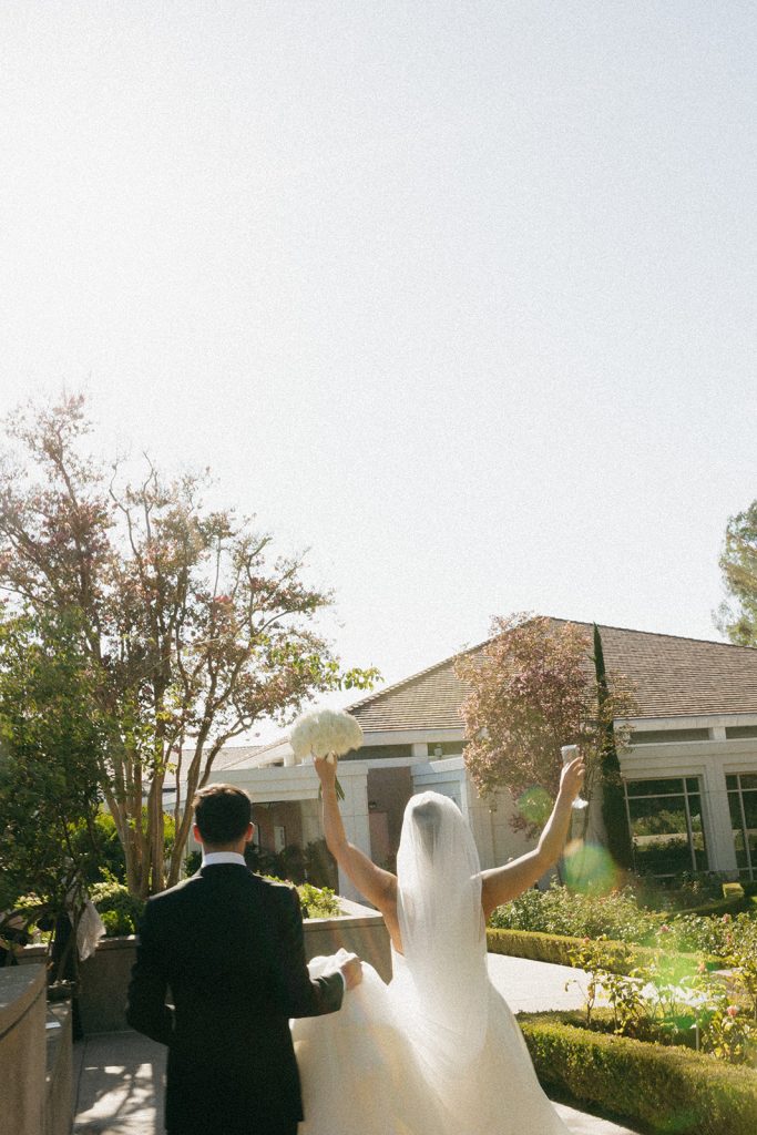 Real Bride Sara wearing her custom tulle blusher veil by Harriett Falvey | Custom Bridal Designer