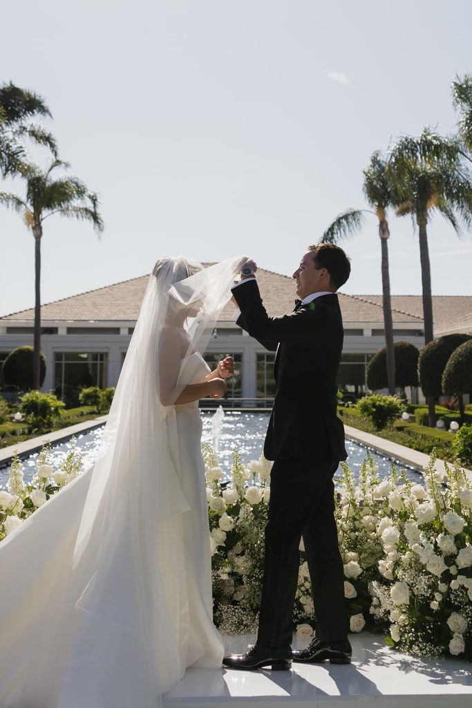 Real Bride Sara wearing her custom tulle blusher veil by Harriett Falvey | Custom Bridal Designer