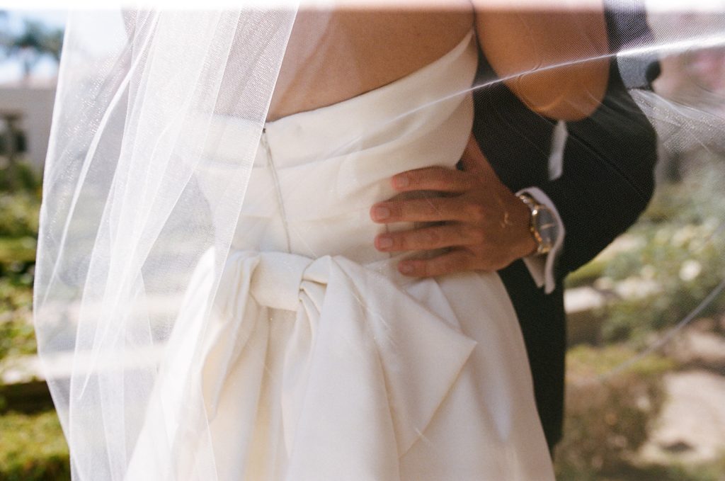 Real Bride Sara wearing her custom tulle blusher veil by Harriett Falvey | Custom Bridal Designer